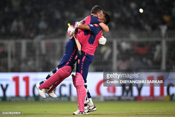 Rajasthan Royals' Jos Buttler and Avesh Khan celebrate their team's win at the end of the Indian Premier League Twenty20 cricket match between...