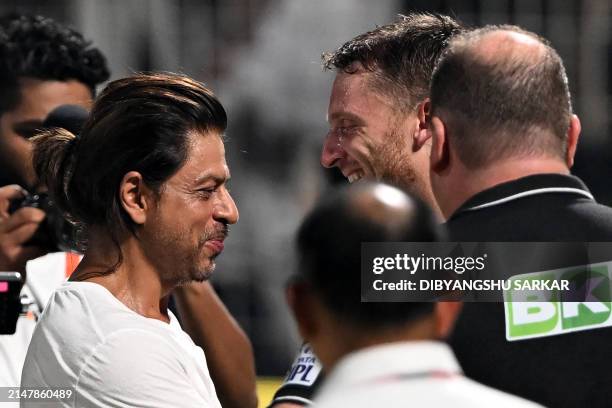 Bollywood actor and co-owner of Kolkata Knight Riders' team Shah Rukh Khan greets Rajasthan Royals' player Jos Buttler at the end of the Indian...