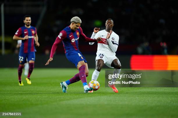 Ronald Araujo centre-back of Barcelona and Uruguay and Nuno Mendes left-back of PSG and Portugal compete for the ball during the UEFA Champions...