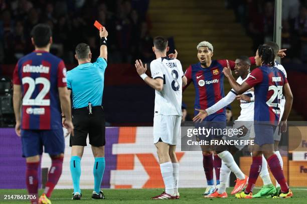 Romanian referee Istvan Kovacs gives a red card to Barcelona's Uruguayan defender Ronald Araujo during the UEFA Champions League quarter-final second...