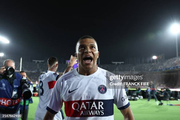 Paris Saint-Germain's French forward Kylian Mbappe celebrates scoring his team's third goal from the penalty spot during the UEFA Champions League...