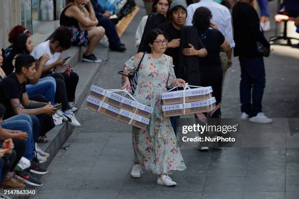 Woman is carrying boxes of bread in the streets of Mexico City's Zócalo. According to the National Water Commission , the thermometer is registering...