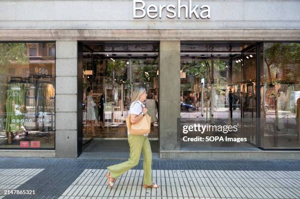 Pedestrian walks past the Spanish fashion brand owned by Inditex, Bershka, store in Spain.