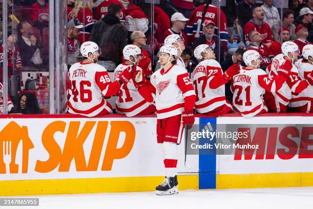 Moritz Seider of the Detroit Red Wings celebrates a goal with the bench during the first period of the NHL regular season game between the Montreal...