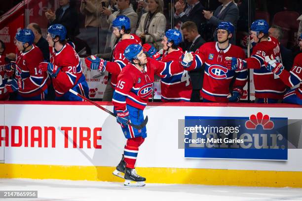 Alex Newhook of the Montreal Canadiens celebrates a goal with the bench during the first period of the NHL regular season game between the Montreal...