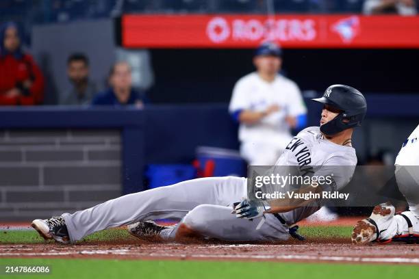 Giancarlo Stanton of the New York Yankees scored a run on an RBI double by Carlos Rodon in the second inning during a game against the Toronto Blue...