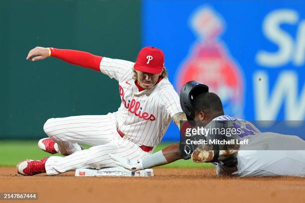 Bryson Stott of the Philadelphia Phillies tags out Elehuris Montero of the Colorado Rockies in the top of the seventh inning at Citizens Bank Park on...