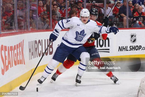 Anton Lundell of the Florida Panthers and David Kampf of the Toronto Maple Leafs battle for control of the puck during second period action at the...
