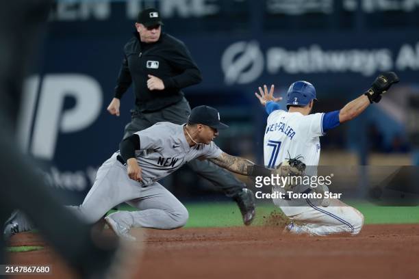 Toronto Blue Jays Isiah Kinder-Falefa sides in safe after stealing second on a dropped ball by Glaber Torres of the New York Yankees in the bottom of...