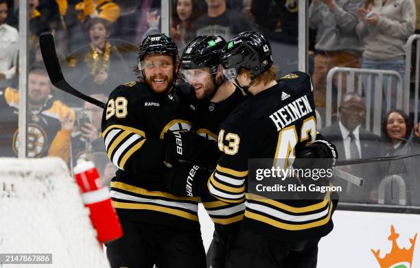 Pavel Zacha of the Boston Bruins celebrates his goal against the Ottawa Senators with his teammates Danton Heinen and David Pastrnak during the third...