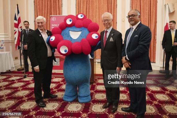 Japanese Ambassador to Britain Hajime Hayashi poses with Myaku-Myaku, the official mascot of the 2025 World Exposition in Osaka, at the Japanese...