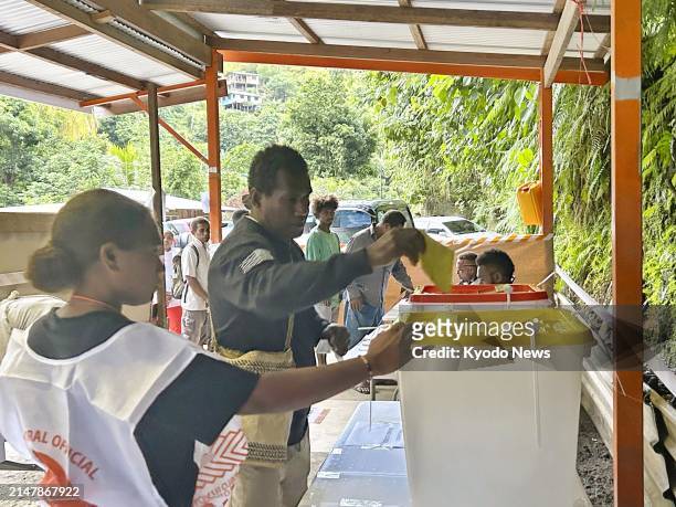 Man casts a ballot at a polling station for a general election in Honiara, the capital of the Solomon Islands, on April 17, 2024.