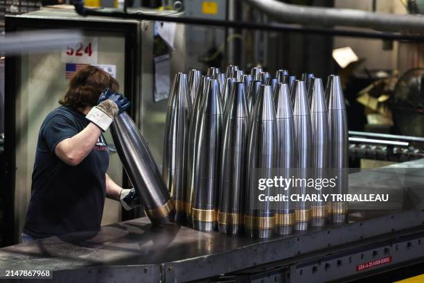 An employee handles 155 mm caliber shells after the manufacturing process at the Scranton Army Ammunition Plant in Scranton, Pennsylvania on April...