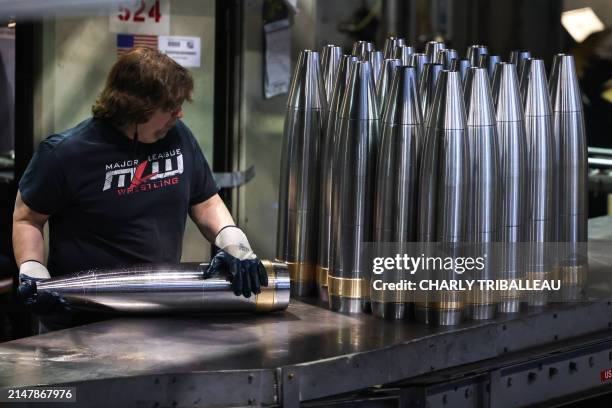An employee handles 155 mm caliber shells after the manufacturing process at the Scranton Army Ammunition Plant in Scranton, Pennsylvania on April...