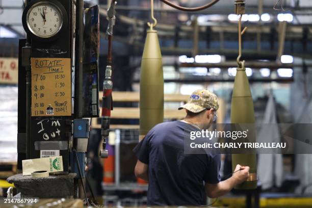 Worker handles 155 mm caliber shells post-manufacturing, preparing them for shipment at the packaging area of the Scranton Army Ammunition Plant in...