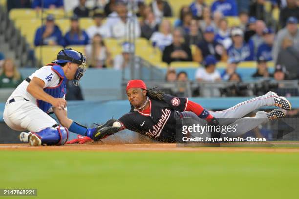 Abrams of the Washington Nationals is tagged out at the plate by Austin Barnes of the Los Angeles Dodgers on a throw from Teoscar Hernández in the...
