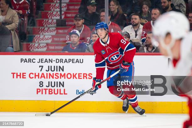 Logan Mailloux of the Montreal Canadiens skates with the puck during the first period of the NHL regular season game between the Montreal Canadiens...