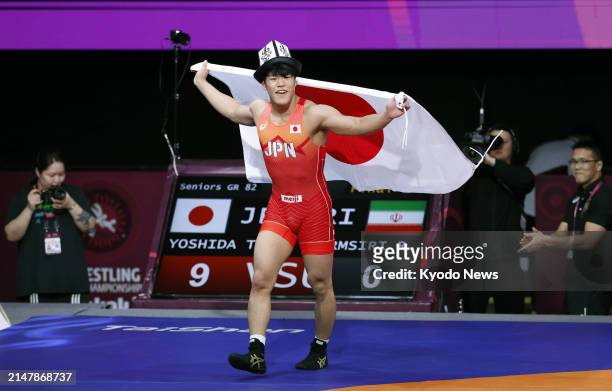 Taizo Yoshida of Japan celebrates after winning the men's Greco-Roman 82-kilogram title at the Asian wrestling championships in Bishkek, Kyrgyzstan,...