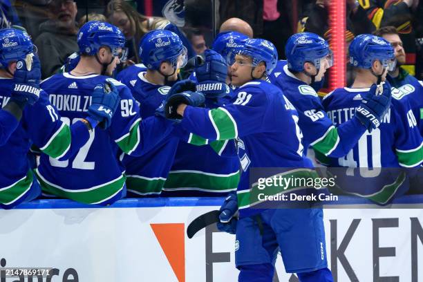 Dakota Joshua of the Vancouver Canucks is congratulated at the bench after scoring a goal against the Calgary Flames during the second period of the...