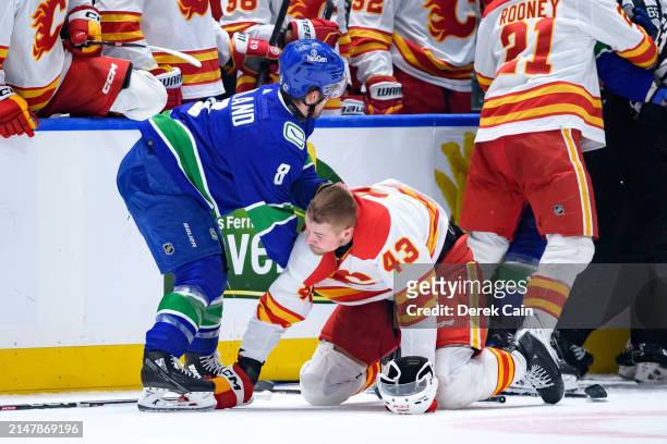 Conor Garland of the Vancouver Canucks fights with Adam Klapka of the Calgary Flames during the second period of the NHL game at Rogers Arena on...