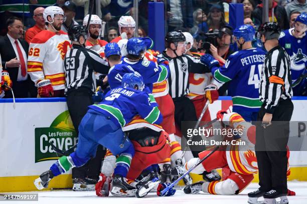 Conor Garland of the Vancouver Canucks fights with Adam Klapka of the Calgary Flames during the second period of the NHL game at Rogers Arena on...