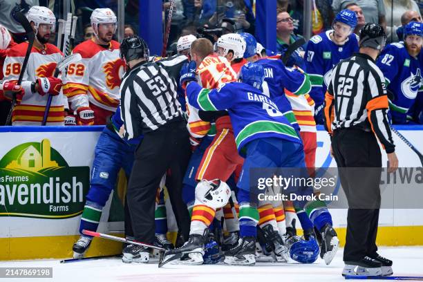 Conor Garland of the Vancouver Canucks fights with Adam Klapka of the Calgary Flames during the second period of the NHL game at Rogers Arena on...