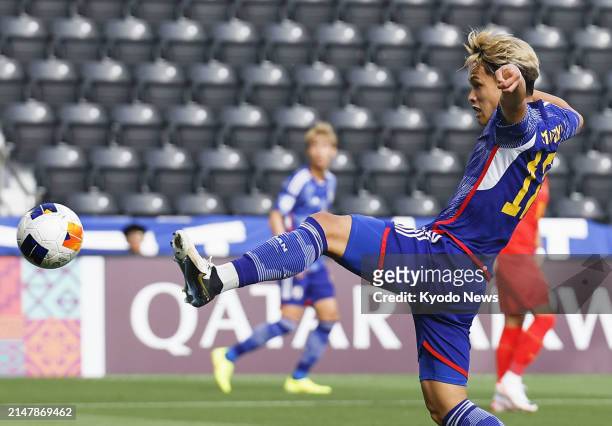 Kuryu Matsuki of Japan scores a goal in the first half of an under-23 Asian Cup men's football group-stage match against China in Doha on April 16,...