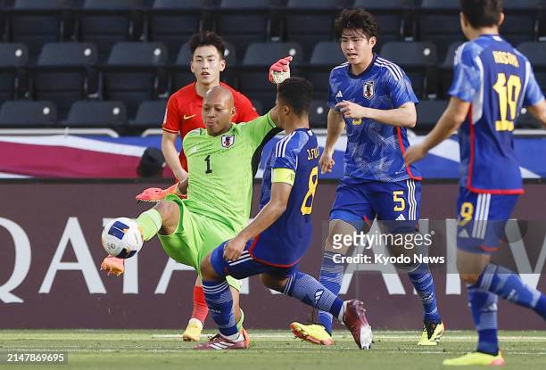 Leo Brian Kokubo of Japan clears the ball during the first half of an under-23 Asian Cup men's football group-stage match against China in Doha on...