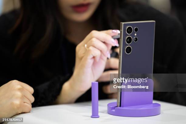 An attendee tries out a Samsung Electronics Co. Galaxy S24 Ultra smartphone at the World IT Show in Seoul, South Korea, on Wednesday, April 17, 2024....