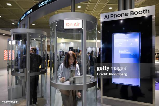 Attendees try out AI traslation using a Samsung Electronics Co. Galaxy S24 smartphone at the World IT Show in Seoul, South Korea, on Wednesday, April...