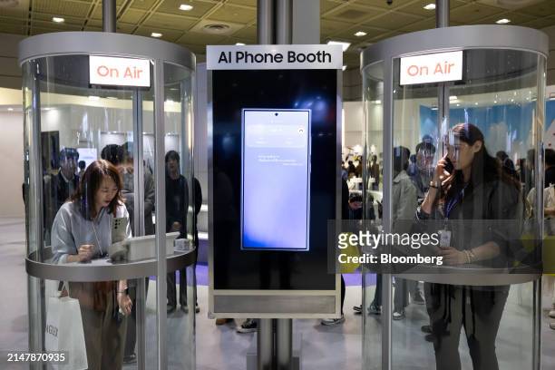 Attendees try out AI traslation using a Samsung Electronics Co. Galaxy S24 smartphone at the World IT Show in Seoul, South Korea, on Wednesday, April...