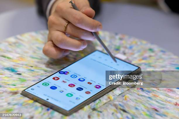 An attendee tries out a Samsung Electronics Co. Galaxy S24 Ultra smartphone at the World IT Show in Seoul, South Korea, on Wednesday, April 17, 2024....