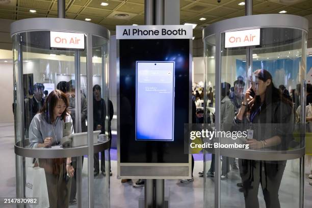 Attendees try out AI traslation using a Samsung Electronics Co. Galaxy S24 smartphone at the World IT Show in Seoul, South Korea, on Wednesday, April...