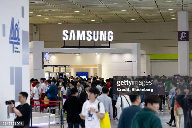 Attendees walk past a Samsung Electronics Co. Booth at the World IT Show in Seoul, South Korea, on Wednesday, April 17, 2024. The show runs through...