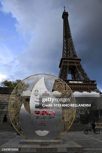 Countdown clock for the Paris 2024 Olympic Games, indicates 100 days before the start of the opening ceremony, in front of the Eiffel Tower in Paris,...