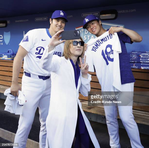 Japanese musician and songwriter Yoshiki takes a selfie with Los Angeles Dodgers designated hitter Shohei Ohtani and pitcher Yoshinobu Yamamoto in...