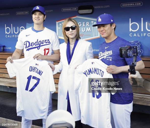 Los Angeles Dodgers designated hitter Shohei Ohtani and pitcher Yoshinobu Yamamoto poses for photos with Japanese musician and songwriter Yoshiki in...