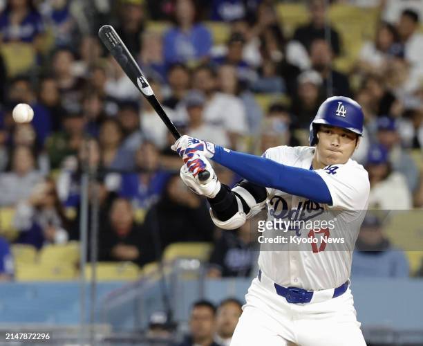 Los Angeles Dodgers designated hitter Shohei Ohtani singles during the eighth inning of a baseball game against the Washington Nationals at Dodger...