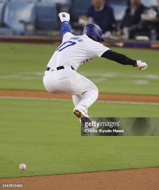Los Angeles Dodgers designated hitter Shohei Ohtani jumps to avoid a ground ball hit by teammate Teoscar Hernandez during the first inning of a...