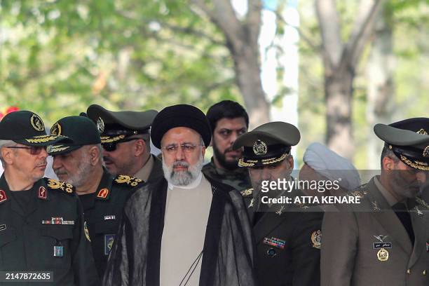 Iran's President Ebrahim Raisi attends a military parade alongside high-ranking officials and commanders during a ceremony marking the country's...