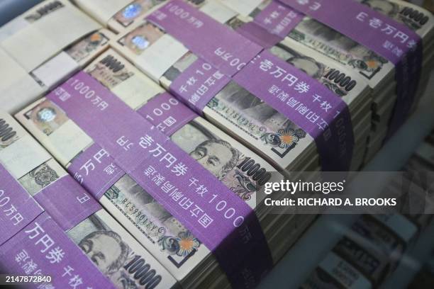 This general view shows 10,000 yen notes on display in the window of a currency exchange shop in central Tokyo on April 17 as the yen continues its...