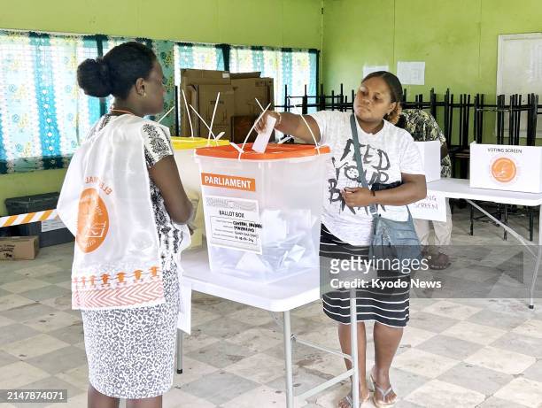 Woman casts a ballot at a polling station for a general election in Honiara, the capital of the Solomon Islands, on April 17, 2024.