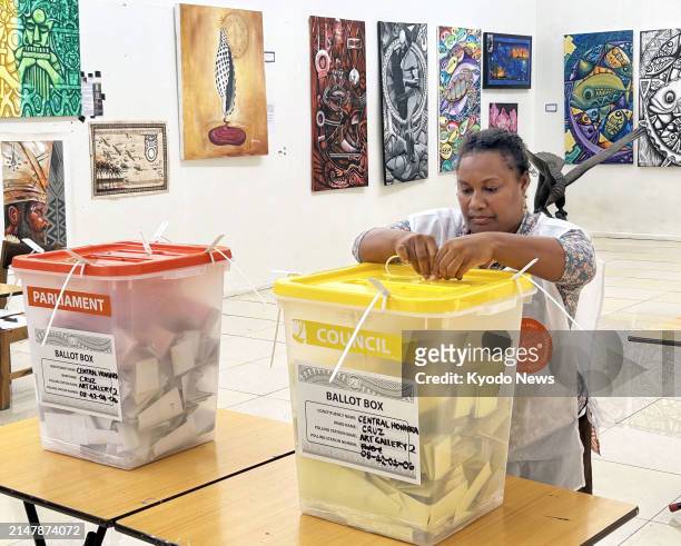 An official puts a ballot box on a table at a polling station after the polls closed for a general election in Honiara, the capital of the Solomon...