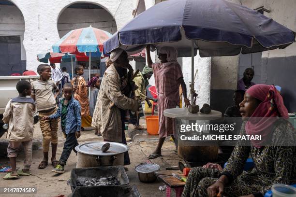 People gather at a meat market inside Harar walled city on April 17, 2024. Founded in the 10th century, Harar - also called Jugol - is reputed to be...