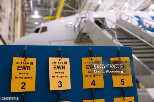 Safety lockout tags in a United Airlines maintenance hangar at Newark Liberty International Airport in Newark, New Jersey, US, on Tuesday, March 19,...