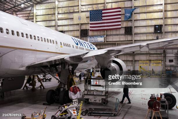 Worker walks under a Boeing 767-300 airplane in a United Airlines maintenance hanger at Newark Liberty International Airport in Newark, New Jersey,...