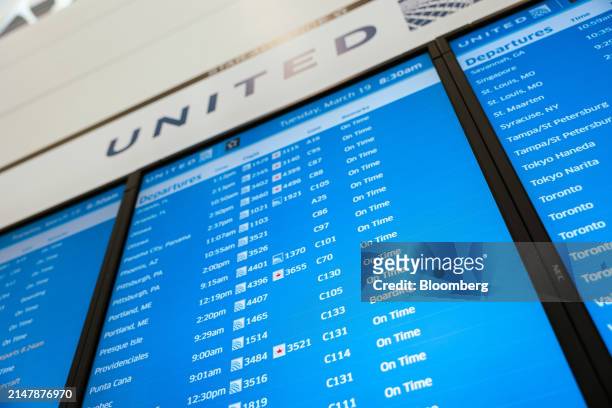 Board displays United Airlines flight times in Terminal C at Newark Liberty International Airport in Newark, New Jersey, US, on Tuesday, March 19,...