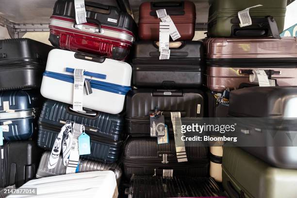 Luggage in a container in the Terminal C baggage room at Newark Liberty International Airport in Newark, New Jersey, US, on Tuesday, March 19, 2024....