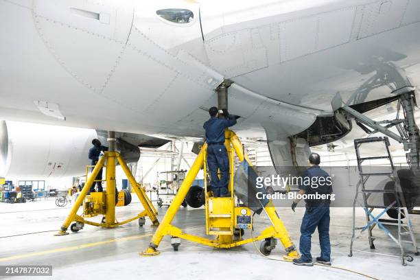 Workers in a United Airlines maintenance hangar at Newark Liberty International Airport in Newark, New Jersey, US, on Tuesday, March 19, 2024. United...