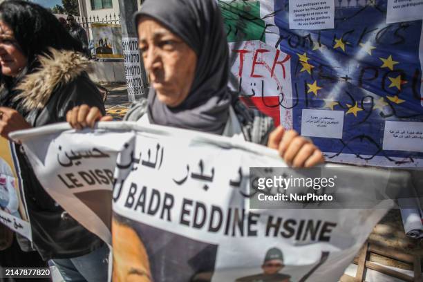 Mother is holding up a poster with the portrait of her missing migrant son during a demonstration in front of the Italian Embassy in Tunis, Tunisia,...